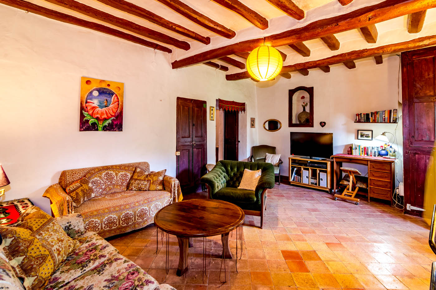 Flat TV and desk with some books