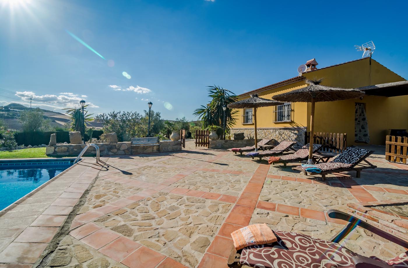 La zona de la piscina está cerrada en parte con césped