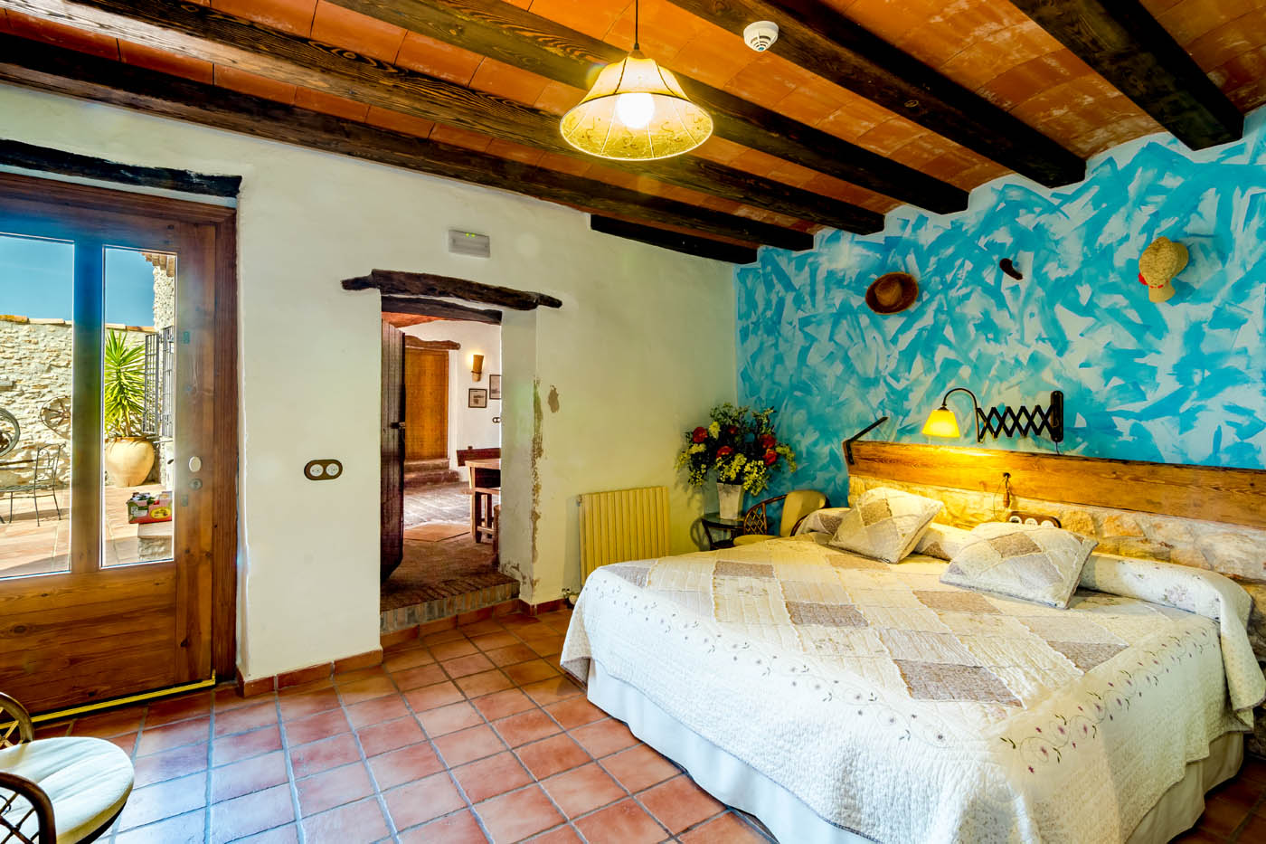 Bedroom on ground floor with doors to patio