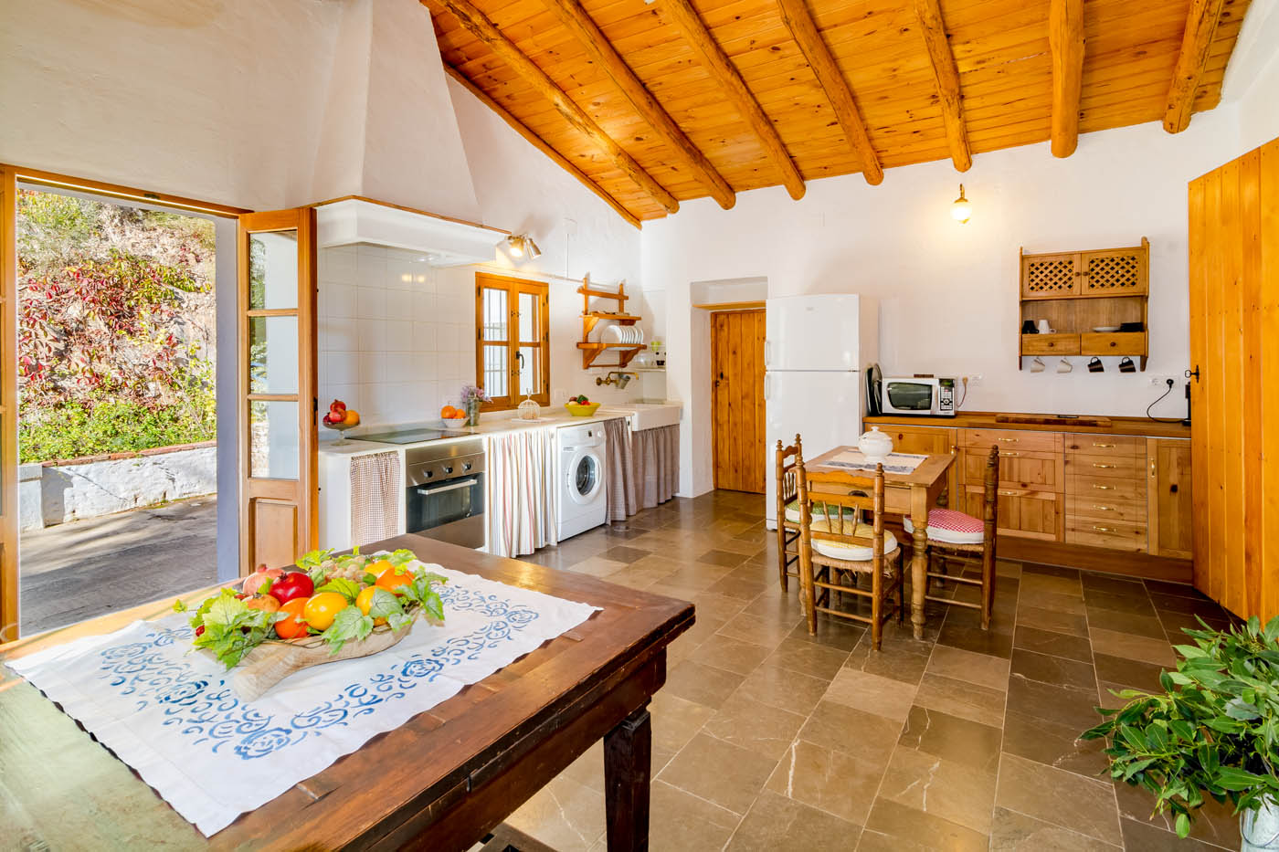 The kitchen opens onto patio
