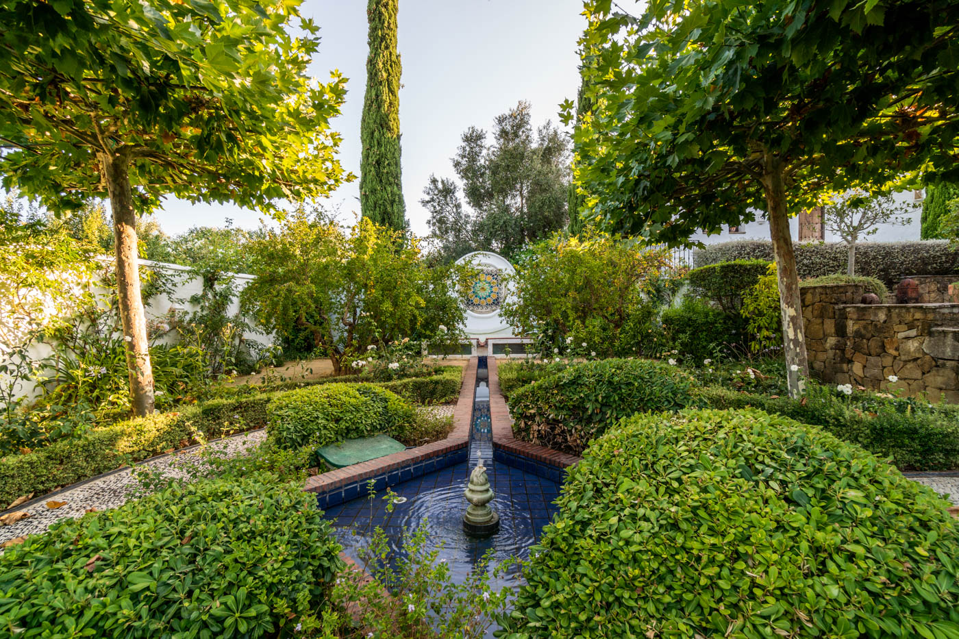 Mosaic fountain with water flowing down channel