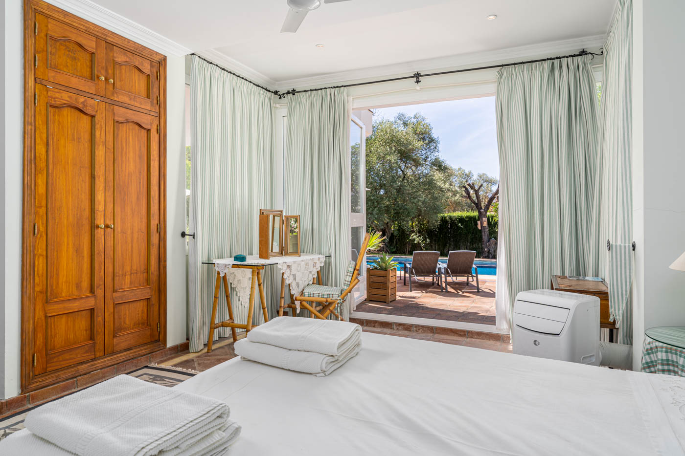 Ground floor bedroom with doors to pool terrace