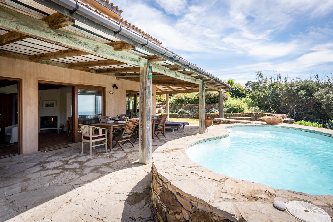 The pool is next to the house