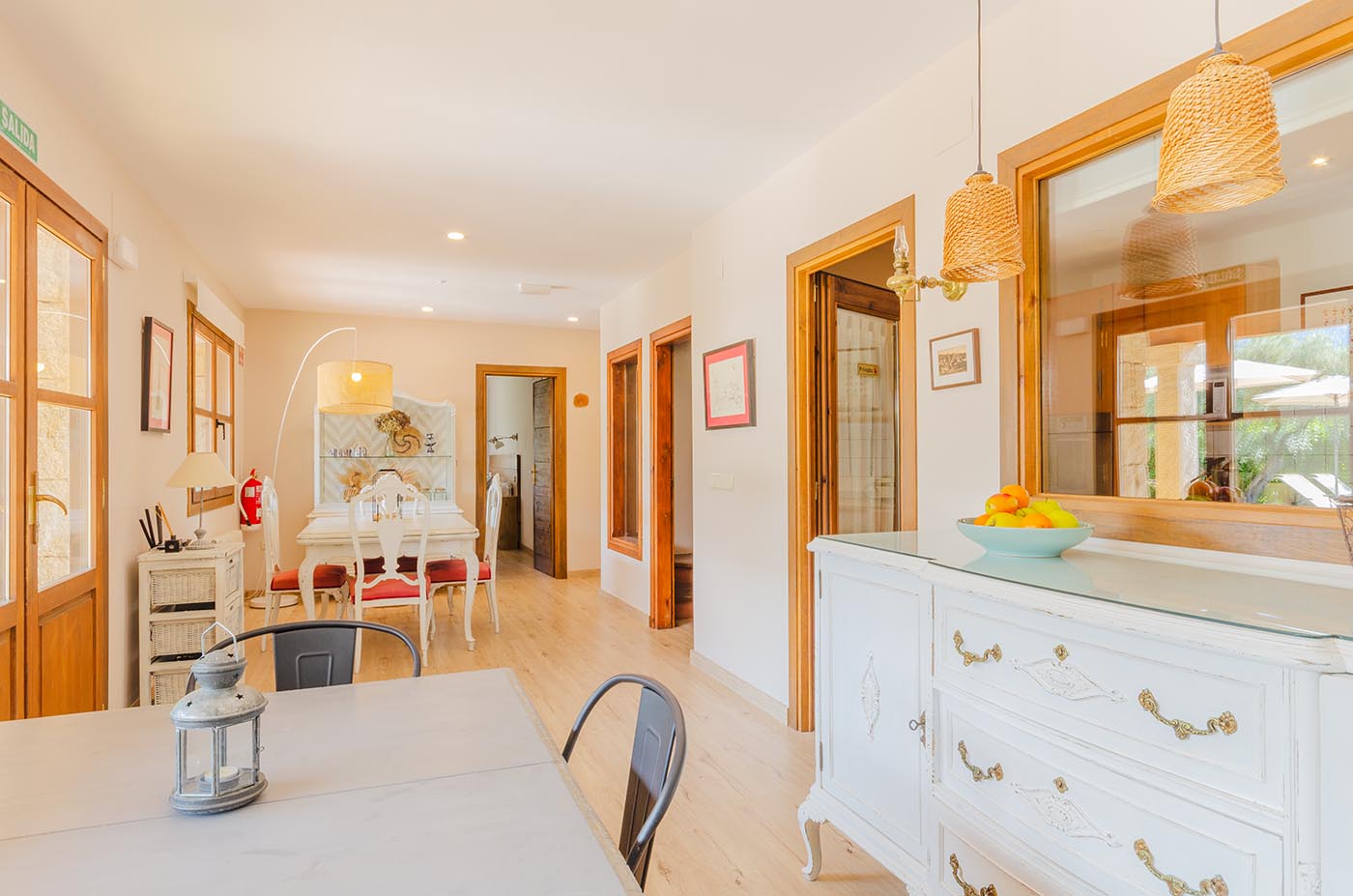 Lower floor dining area with kitchen and doors to gardens