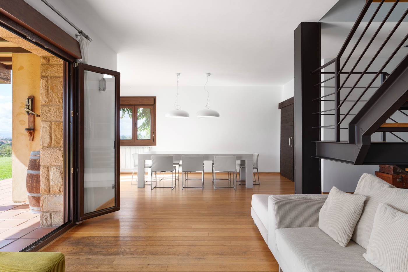 Living and dining areas with doors to gardens and pool