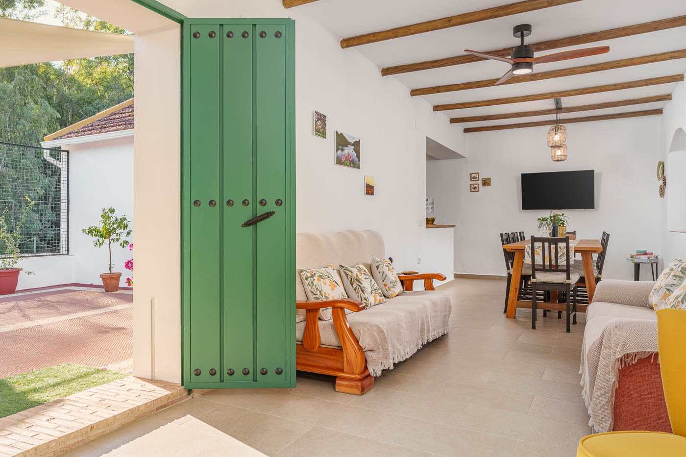 Main door to living and living area with kitchen on the left