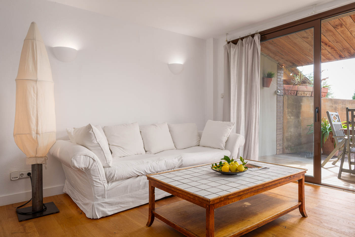 Living area with doors opening to furnished porch/garden