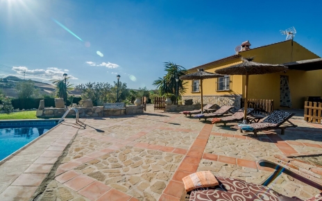 La zona de la piscina está cerrada en parte con césped