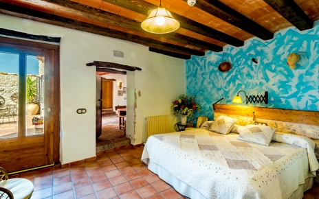 Bedroom on ground floor with doors to patio