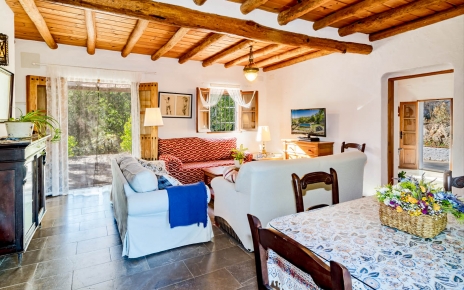 Living / dining space with doors to terrace and gardens