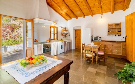 The kitchen opens onto patio