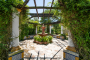 Pretty courtyard with pergola and climbers 