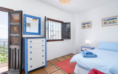 Habitación con una cama y balcón en primera planta