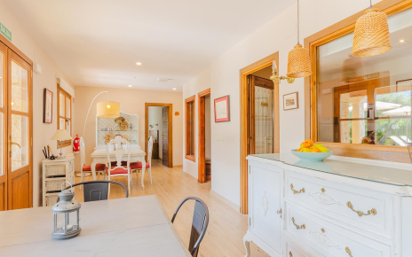 Lower floor dining area with kitchen and doors to gardens
