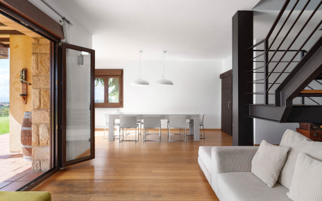 Living and dining areas with doors to gardens and pool