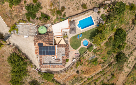 Villa, pool and gardens seen from a drone
