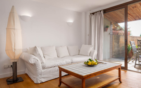 Living area with doors opening to furnished porch/garden