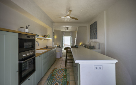 A lovely kitchen with doors opening to terrace